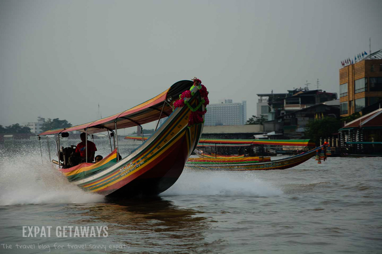 River boats zip along the Chao Praya River